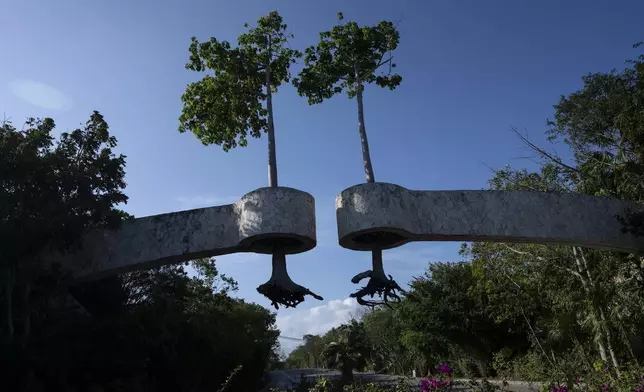 FILE PHOTO GALLERY - Uprooted trees serving as decor are suspended over the entrance of a tourist complex in Playa del Carmen, Mexico, March 7, 2024. Once a Mayan settlement, the city is among many in the Yucatan Peninsula that in recent decades have been converted into a party hub for vacationing foreigners. (AP Photo/Rodrigo Abd)