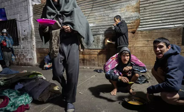 FILE PHOTO GALLERY - Prisoners eat a jail-provided soup known as "vori vori" at the Tacumbu prison in Asuncion, Paraguay, July 8, 2024. The soup, made of chicken or beef, vegetables, and corn balls stuffed with cheese, is considered the food of the poorest inmates. (AP Photo/Rodrigo Abd)