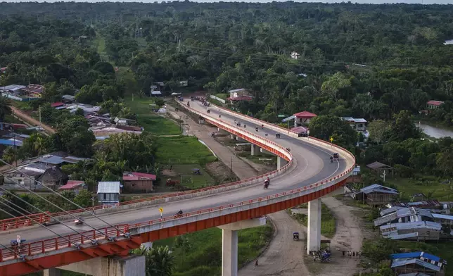 FILE PHOTO GALLERY - Residents drive on a bridge, part of a federal highway project that extends over the Nanay River, in Iquitos, Peru, May 26, 2024. Construction work is at a standstill as the government conducts a study of the area, but the Ministry of Transportation has already built what is the country's largest bridge, which extends 2.3 kilometers (1.4 miles) over the Nanay, a tributary of the Amazon River. (AP Photo/Rodrigo Abd)