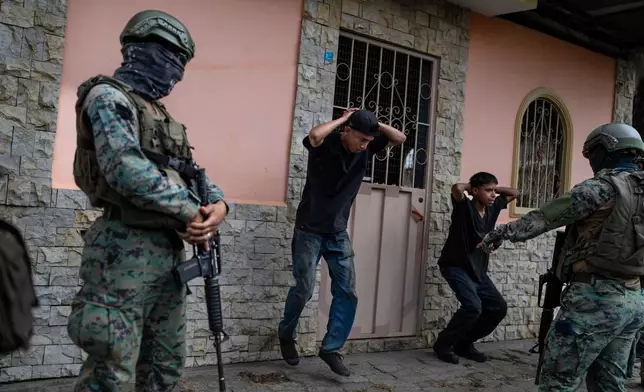 FILE PHOTO GALLERY - Soldiers on patrol force young men into doing squats as punishment for not having the proper documents to circulate their motorcycle, in Duran, Ecuador, Sept. 30, 2023. (AP Photo/Rodrigo Abd)