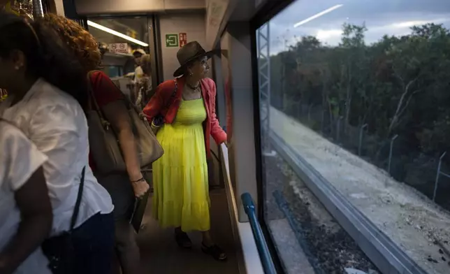 FILE PHOTO GALLERY - A passenger looks at the passing jungle landscape while traveling on the Maya Train from Cancun to Valladolid, Mexico, March 6, 2024. (AP Photo/Rodrigo Abd)