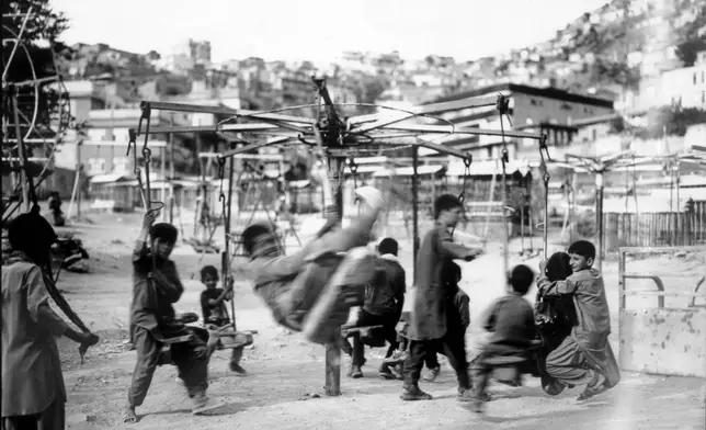 FILE PHOTO GALLERY - Children play on swings near the Kart-e Sakhy cemetery in Kabul, Afghanistan, June 8, 2023. (AP Photo/Rodrigo Abd, File)