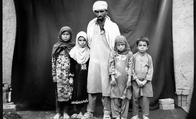 FILE PHOTO GALLERY - Seasonal brick worker Ibrahim poses for a portrait with his children, from left to right, Arzo,10; Okhkulah, 9; Rana, 8; and Abobaker, 7, while taking a break from working in a brick factory on the outskirts of Kabul, Afghanistan, May 30, 2023. (AP Photo/Rodrigo Abd, File)