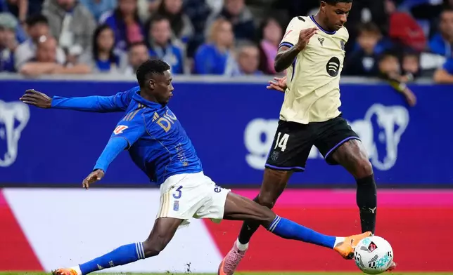 Barcelona's Marcus Rashford fights for the ball against Real Oviedo's Rahim Alhassane during a Spanish La Liga soccer match at the Carlos Tartiere stadium in Oviedo, Spain, Thursday, Sept. 25, 2025. (AP Photo/Jose Breton)