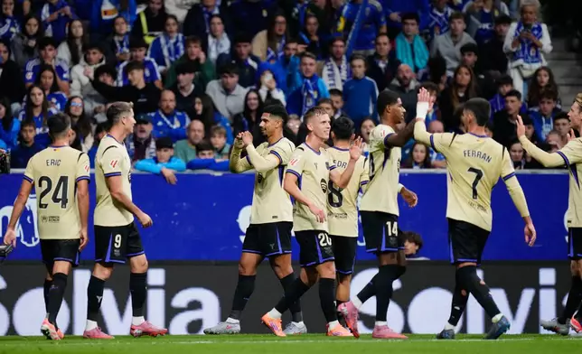 Barcelona's Ronald Araujo celebrates his side's third goal during a Spanish La Liga soccer match at the Carlos Tartiere stadium in Oviedo, Spain, Thursday, Sept. 25, 2025. (AP Photo/Jose Breton)