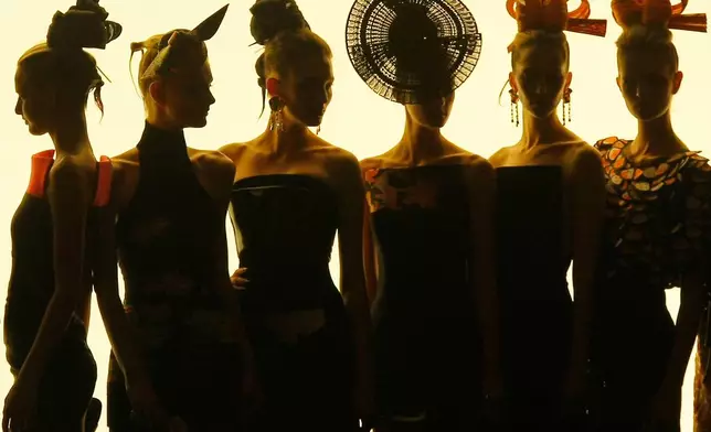 FILE - Models wear creations for the Giorgio Armani Fall-Winter 2011-2012 Haute Couture fashion collection presented in Paris, July 5, 2011. (AP Photo/Jacques Brinon, file)