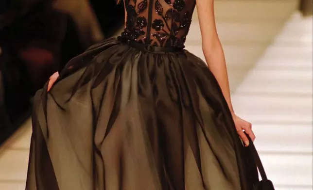FILE - A beautiful black beaded evening gown at Giorgio Armani's fashion collection, which concludes the Spring-Summer ready-to-wear collections, in Milan, Oct. 10 1995. (AP Photo/Luca Bruno, file)