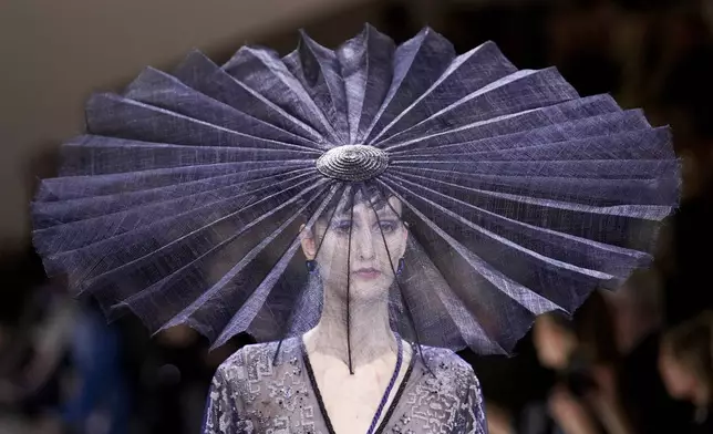 FILE - A model wears a creation for Giorgio Armani Prive as part of the Haute Couture Spring-Summer 2024 collection presented in Paris, Jan. 23, 2024. (AP Photo/Christophe Ena, file)