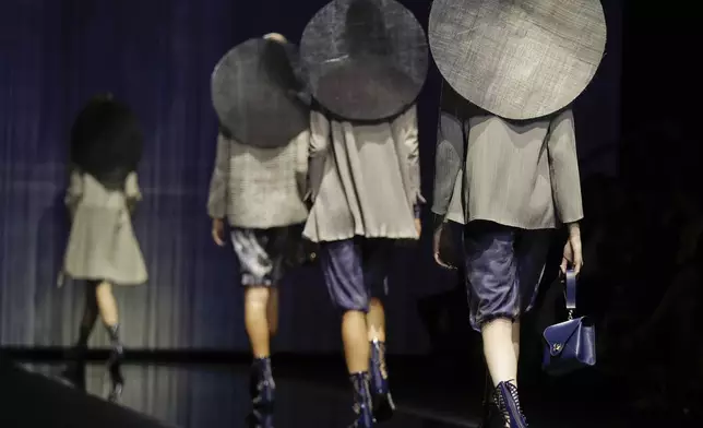FILE - Models wear creations part of the Giorgio Armani women's Spring-Summer 2017 collection, that was presented in Milan, Italy, Sept. 23, 2016. (AP Photo/Luca Bruno, file)