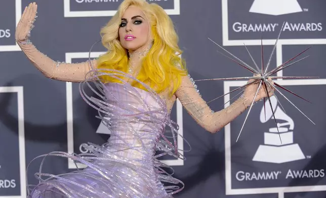FILE - This Jan. 31, 2010 file photo shows Lady Gaga arriving at the Grammy Awards in Los Angeles wearing a futuristic lavender dress by Armani Prive. (AP Photo/Chris Pizzello, file)