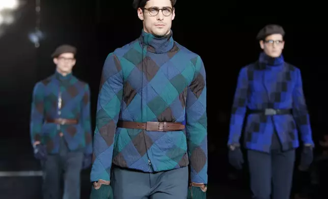 FILE - Models wear a creations of the Giorgio Armani men's Fall-Winter 2010/2011 collection, part of the Milan fashion week, unveiled in Milan, Italy, Tuesday, Jan. 19, 2010. (AP Photo/Luca Bruno, file)