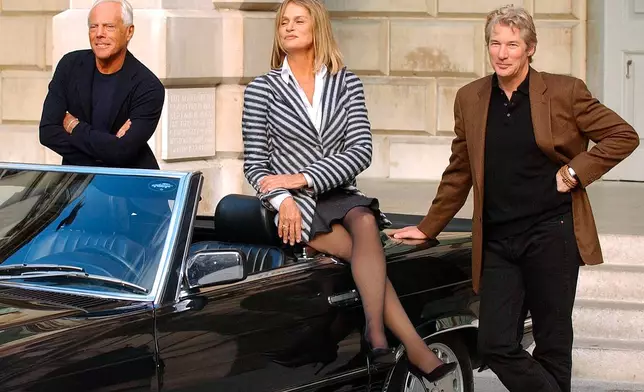 FILE - American movie stars Richard Gere, right, and Lauren Hutton, center, who were both dressed in Armani clothes when they starred in the film "American Gigolo" join up with fashion designer Giorgio Armani, left, during a photocall at the Royal Academy of Arts in London, Oct. 14, 2003. (AP Photo/Richard Lewis, file)