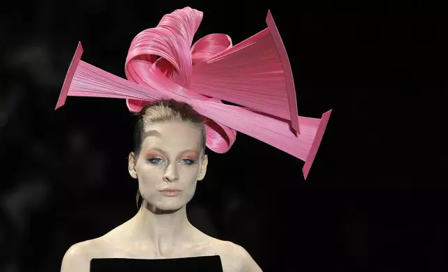 FILE - A model wears a creation for the Giorgio Armani Fall-Winter 2011-2012 Haute Couture fashion collection presented in Paris, July 5, 2011. (AP Photo/Jacques Brinon, file)