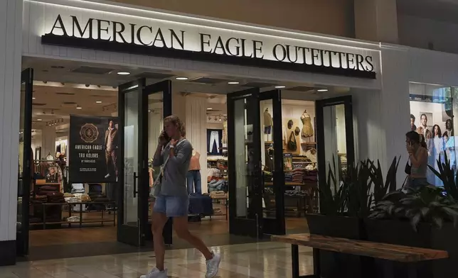 Shoppers walk by an American Eagle Outfitters, Thursday, Sept. 4, 2025, in Bellevue, Wash. (AP Photo/Lindsey Wasson)