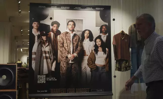 A shopper walks by an ad featuring Kansas City Chiefs' Travis Kelce outside an American Eagle Outfitters, Thursday, Sept. 4, 2025, in Bellevue, Wash. (AP Photo/Lindsey Wasson)
