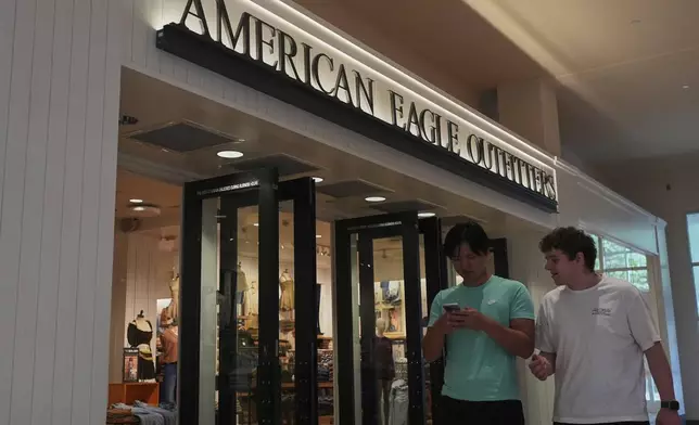Shoppers walk by an American Eagle Outfitters, Thursday, Sept. 4, 2025, in Bellevue, Wash. (AP Photo/Lindsey Wasson)
