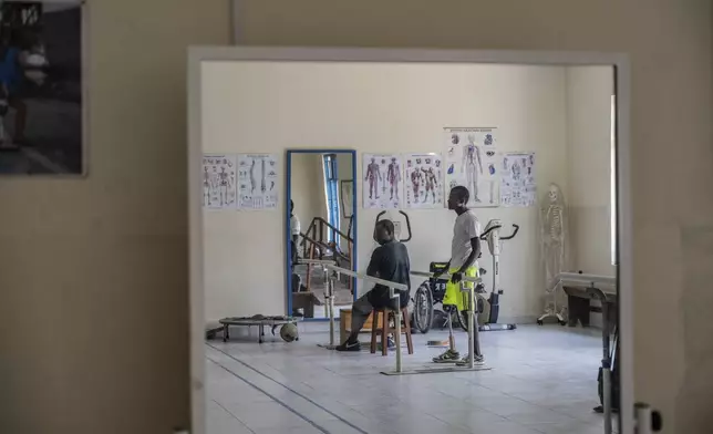 Amputees, many wounded by fighting in the region, exercise at an orthopedic center run by the Catholic church and supported by Red Cross in Goma, eastern Congo, Friday, Aug. 29, 2025. (AP Photo/Moses Sawasawa)