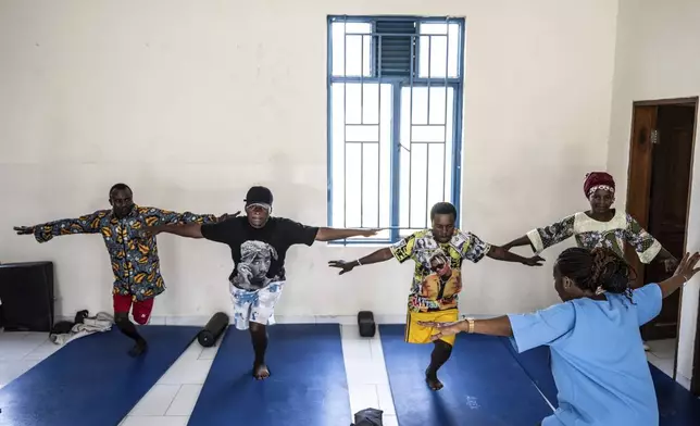Physiotherapist Gisèle Kantu, bottom right, works with amputees wounded by fighting in the region, at an orthopedic center run by the Catholic church and supported by Red Cross in Goma, eastern Congo, Friday, Aug. 29, 2025. (AP Photo/Moses Sawasawa)