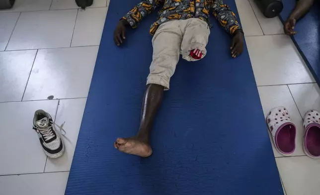A victim of fighting in the region, waits for physiotherapy at an orthopedic center run by the Catholic church and supported by Red Cross in Goma, eastern Congo, Friday, Aug. 29, 2025. (AP Photo/Moses Sawasawa)
