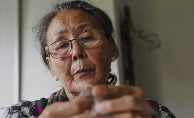 66-year-old retiree Kirstine Berthelsen prepares wool for sewing at her home in northern Copenhagen, Denmark, Sept. 17, 2025. (AP Photo/James Brooks)