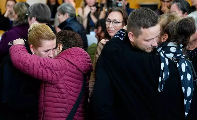 Greenland's Prime Minister Jens-Frederik Nielsen, and Danish Prime Minister Mette Frederiksen, left, greet and apologize to the affected women after a meeting in the cultural house Katuaq in Nuuk, Greenland, Wednesday Sept. 24, 2025. (Mads Claus Rasmussen/Ritzau Scanpix via AP)