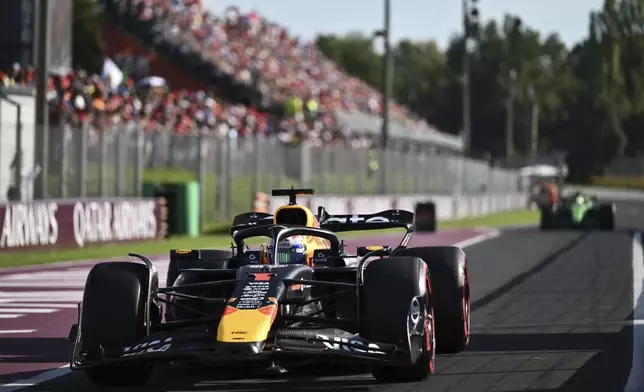 Red Bull driver Max Verstappen of the Netherlands returns to the parc ferme after winning the pole position in the qualifying session ahead of the Italian Grand Prix at the Monza racetrack in Monza, Italy, Saturday, Sept. 6, 2025. (Marco Bertorello/Pool Photo via AP)