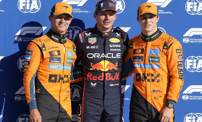 Red Bull driver Max Verstappen of the Netherlands, centre, celebrates his pole position with McLaren driver Lando Norris of Britain, left, and McLaren driver Oscar Piastri of Australia after the qualifying session ahead of the Italian Grand Prix at the Monza racetrack in Monza, Italy, Saturday, Sept. 6, 2025. (AP Photo/Luca Bruno)