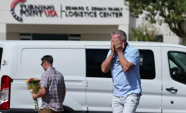 A well-wisher is overcome after dropping off flowers, Wednesday, Sept. 10, 2025, at the national headquarters of Turning Point USA in Phoenix, following the shooting death of Charlie Kirk, the 31-year-old CEO of the organization, at a Utah college. (AP Photo/Ross D. Franklin)