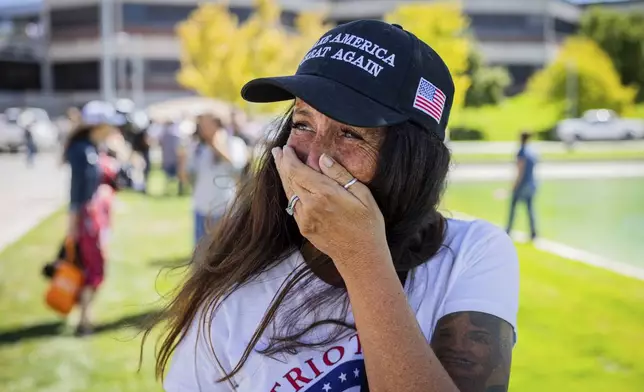 Allison Hemingway-Witty cries after Charlie Kirk is shot during Turning Point's visit to Utah Valley University in Orem, Utah, Wednesday, Sept. 10, 2025. (Tess Crowley/The Deseret News via AP)