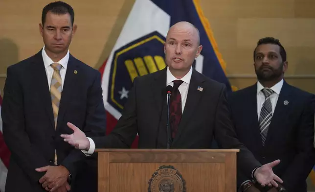 Utah Gov. Spencer Cox speaks at a news conference, as Utah department of public safety commissioner Beau Mason, left, and FBI Director Kash Patel listens, Friday, Sept. 12, 2025, in Orem, Utah,(AP Photo/Lindsay Wasson)