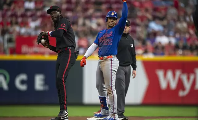 New York Mets' Juan Soto (22) celebrates after hitting a double in the third inning of a baseball game against the Cincinnati Reds, Friday, Sept. 5, 2025, in Cincinnati. (AP Photo/Michael Swensen)