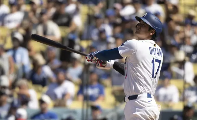 Los Angeles Dodgers' Shohei Ohtani tracks his fly ball during the seventh inning of a baseball game against the Arizona Diamondbacks in Los Angeles, Sunday, Aug. 31, 2025. (AP Photo/Kyusung Gong)