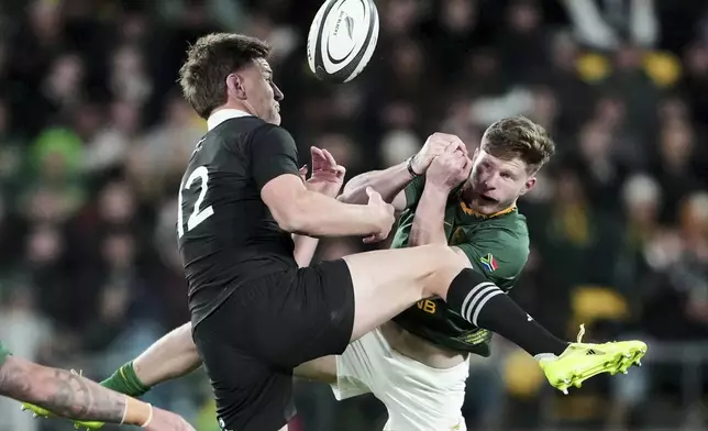 All Blacks Jordie Barrett, left, jumps for the ball with South Africa's Ethan Hooker during their Rugby Championship test match in Wellington, New Zealand, Saturday, Sept. 13, 2025. (AP Photo/Marty Melville)