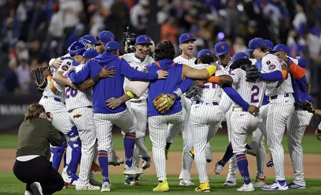 The New York Mets celebrate after defeating the San Diego Padres in a baseball game Tuesday, Sept. 16, 2025, in New York. (AP Photo/Adam Hunger)