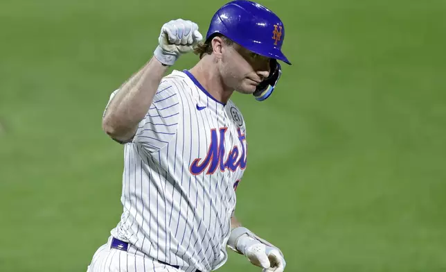 New York Mets' Pete Alonso reacts after hitting a home run during the second inning of a baseball game against the San Diego Padres, Tuesday, Sept. 16, 2025, in New York. (AP Photo/Adam Hunger)