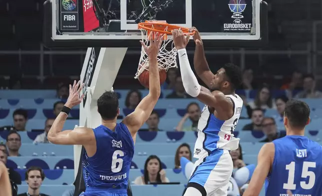 Greece's Giannis Antetokounmpo scores during the Eurobasket, European Basketball Championship round of 16 match between Greece and Israel at the Riga Arena in Riga, Latvia, Sunday, Sept. 7, 2025. (AP Photo/Sergei Grits)