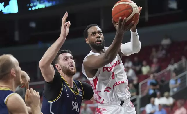 Bosnia's Jusuf Nurkic, left, and Poland's Jordan Loyd in action during the Eurobasket, European Basketball Championship round of 16 match between Poland and Bosnia and Herzegovina at the Riga Arena in Riga, Latvia, Sunday, Sept. 7, 2025. (AP Photo/Sergei Grits)