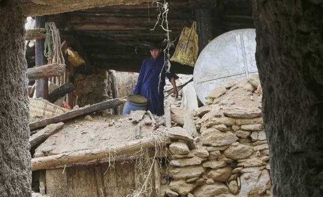 A boy walks through a partially collapsed house in an area devastated by Sunday's powerful 6.0-magnitude earthquake that killed many people and destroyed villages in eastern Afghanistan, in Dara Noor, Kunar province, Tuesday, Sept. 2, 2025,. (AP Photo/Wahidullah Kakar)