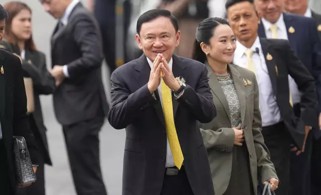 Thailand's former Prime Minister Thaksin Shinawatra, center, and his daughter and former Prime Minister Paetongtarn Shinawatra, right, arrive at Supreme Court in Bangkok, Thailand, Tuesday, Sept. 9, 2025. (AP Photo/Sakchai Lalit)