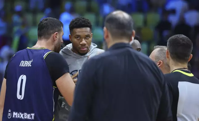 Bosnia's Jusuf Nurkic, left, speaks with Greece's Giannis Antetokounmpo after the end of the Eurobasket, European Basketball Championship Group C match between Greece and Bosnia at Spyros Kyprianou Arena, in Limassol, Cyprus, Tuesday, Sept. 2, 2025. (AP Photo/Chara Savvidou)