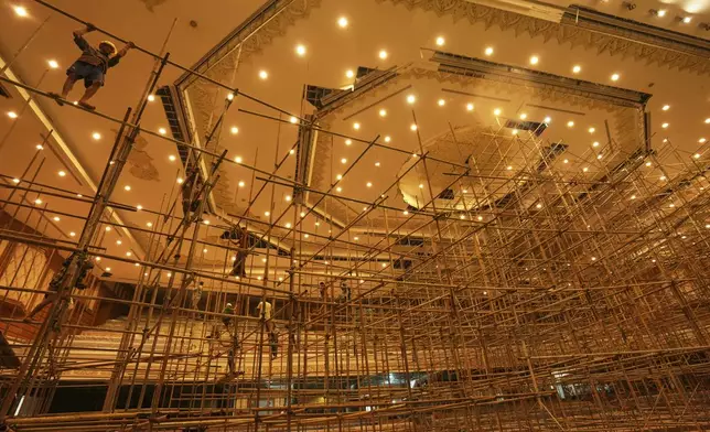 Laborers work inside a parliament building that was damaged in the March 28 earthquake in Naypyitaw, Myanmar, Thursday, Aug. 28, 2025. (AP Photo/Aung Shine Oo)