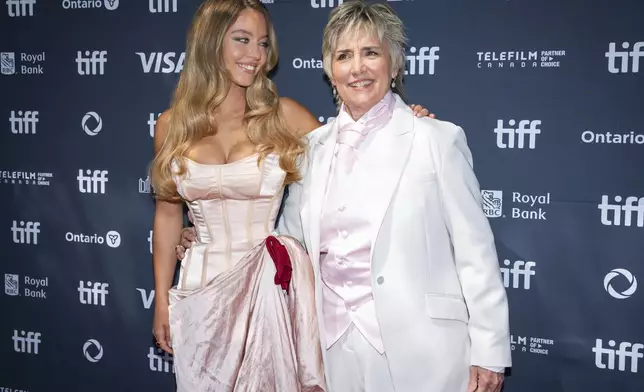 Sydney Sweeney and Christy Salters pose for photographs as they walk the red carpet at the premiere of "Christy" at the Toronto International Film Festival in Toronto on Friday, Sept. 5, 2025. (Arlyn McAdorey /The Canadian Press via AP)