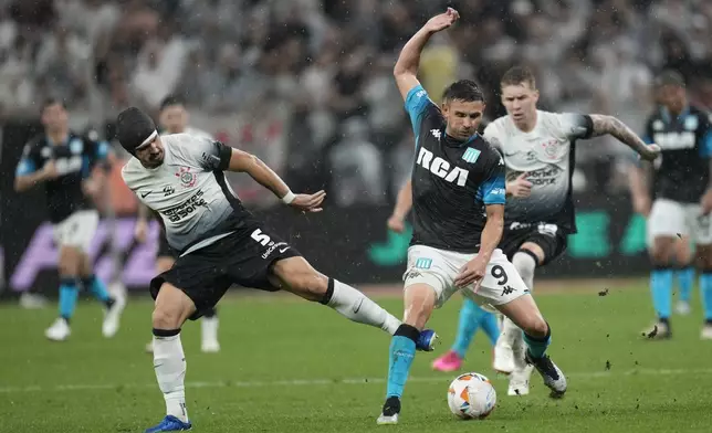 FILE - Andre Ramalho of Brazil's Corinthians, left, and Adrian Martinez of Argentina's Racing Club battle for the ball during a Copa Sudamericana semifinal first leg soccer match at Neo Quimica arena in Sao Paulo, Oct. 24, 2024. (AP Photo/Andre Penner, File)