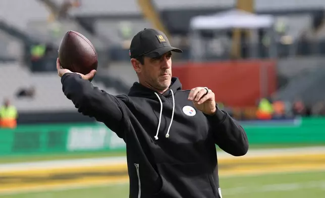 Pittsburgh Steelers quarterback Aaron Rodgers (8) throws a ball to warm up before the start of the NFL football game between Minnesota Vikings and Pittsburgh Steelers at Croke Park stadium in Dublin, Sunday, Sept. 28, 2025.(AP Photo/Ian Walton)