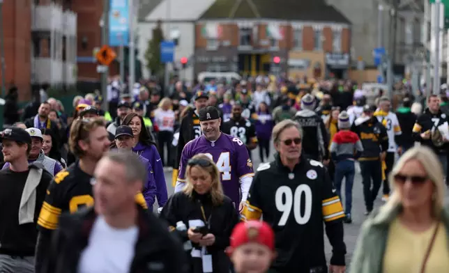 Fans arrive before the start of the NFL football game between Minnesota Vikings and Pittsburgh Steelers at Croke Park stadium in Dublin, Sunday, Sept. 28, 2025.(AP Photo/Ian Walton)