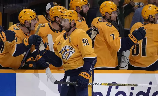 Nashville Predators center Steven Stamkos (91) celebrates his goal with teammates during the first period of an NHL preseason hockey game against the Florida Panthers, Sunday, Sept. 21, 2025, in Nashville, Tenn. (AP Photo/George Walker IV)