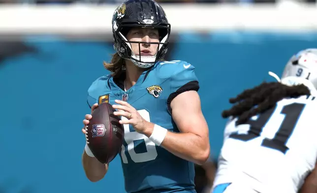 Jacksonville Jaguars quarterback Trevor Lawrence (16) looks to pass the ball against the Carolina Panthers during the second half of an NFL football game, Sunday, Sept. 7, 2025, in Jacksonville, Fla. (AP Photo/John Raoux)