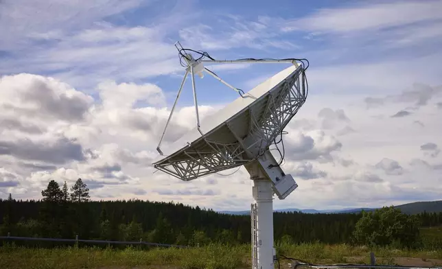 A satellite antenna is pointing at the sky outside the Esrange Space Center, a base deep in the Swedish forest and a part of Europe's hope to compete in the space race in Kiruna, Sweden, Tuesday, Aug. 19, 2025. (AP Photo/Malin Haarala)