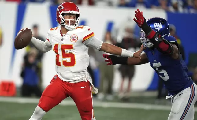 Kansas City Chiefs quarterback Patrick Mahomes throws as New York Giants outside linebacker Kayvon Thibodeaux (5) defends during the second half of an NFL football game Sunday, Sept. 21, 2025, in East Rutherford, N.J. (AP Photo/Seth Wenig)