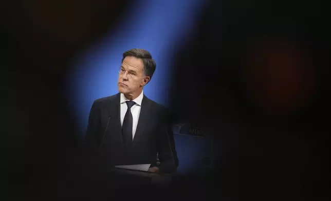NATO Secretary General Mark Rutte listens to questions from journalists during a media conference at NATO headquarters in Brussels, Tuesday, Sept. 23, 2025. (AP Photo/Virginia Mayo)
